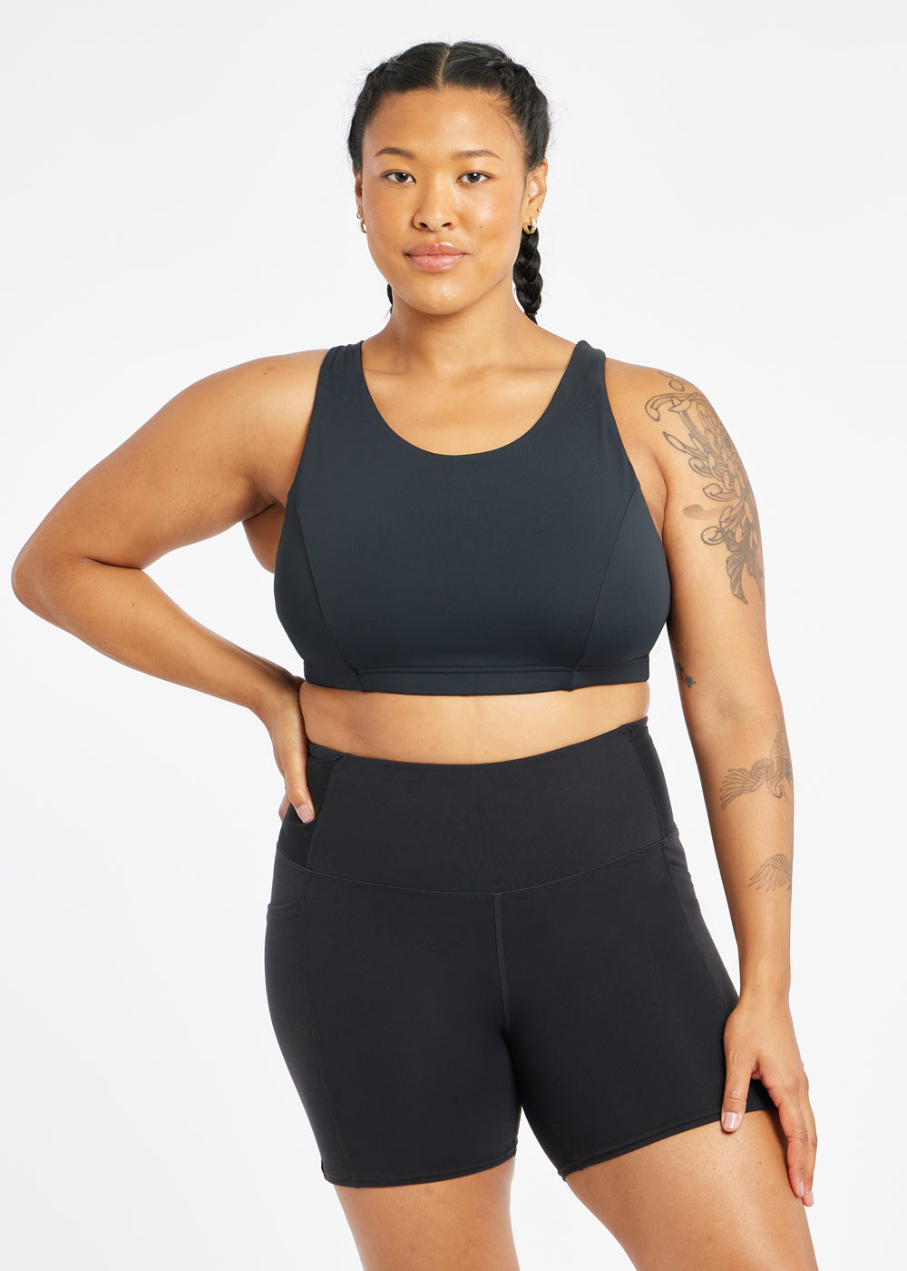 Woman wearing black sports bra in size 12, front view